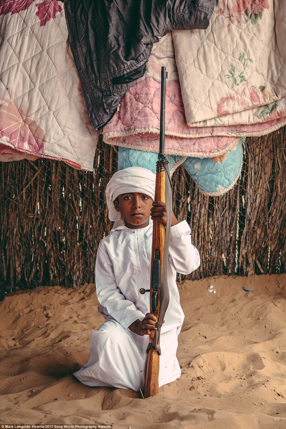 3E4AA65200000578-4315762-A_bedouin_boy_in_Oman_poses_with_his_father_s_rifle_He_is_still_-a-59_1489585076189.jpg